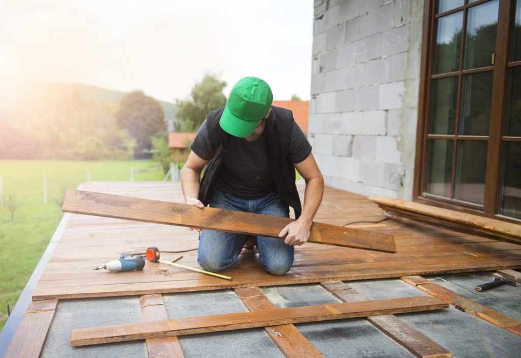 handyman installing wooden flooring e1623129012640